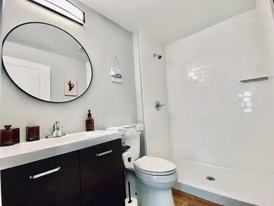 a bathroom with a sink and a toilet and a mirror at 23 COMFORT AND LUXURY 3 BR 2 BA House in Southington