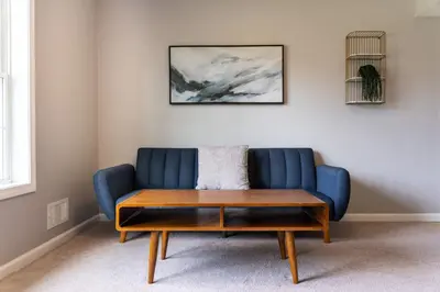 a blue couch with a coffee table in a room at 11 - 4 Bedrooms 3 Baths Sleeps up to 10 in Plainville