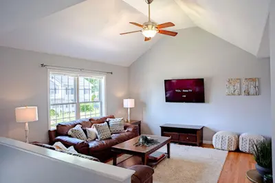 a living room with a couch and a ceiling fan at 11 - 4 Bedrooms 3 Baths Sleeps up to 10 in Plainville