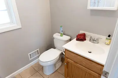 a bathroom with a white toilet and a sink at 2 Beautiful 1 BR Apartment - Central CT in Plainville