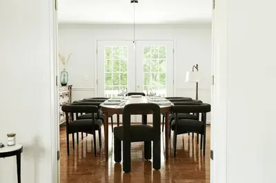 a dining room with a table and black chairs at Beautifully Designed 4BR Home Heated Pool HotTub in Valatie