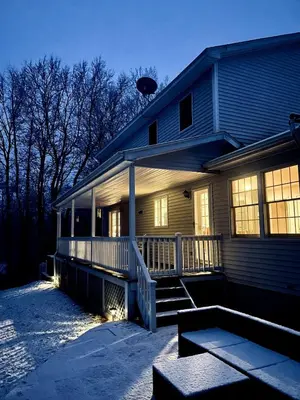 a house with a porch and stairs in front of it at Beautifully Designed 4BR Home Heated Pool HotTub in Valatie
