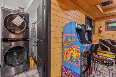 a room with a snowboard next to a washing machine at Pocono River front Home near Camelback Resort in Barton Glen