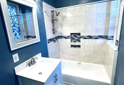 a bathroom with a white sink and a shower at NYC cozy room in Van Nest
