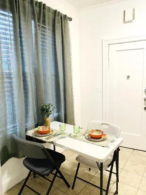 a dining room table with two plates of food on it at NYC cozy room in Van Nest