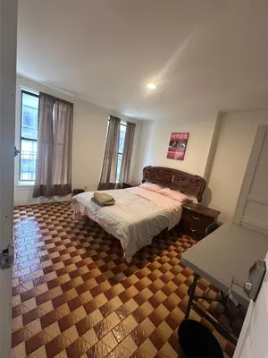 a bedroom with a bed and a table in it at AL Shami 408 in New York