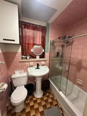 a bathroom with a toilet and a sink and a shower at AL Shami 408 in New York