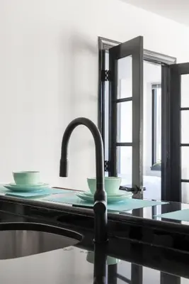 a kitchen sink with two plates and a mirror at Stunning NYC Views! Free Gym! Doorman! Terrace! in New York