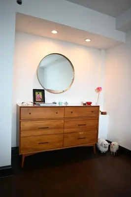 a dresser with a large mirror on a wall at Doorman! High Floor! Views! Elevator! Free Gym! in New York