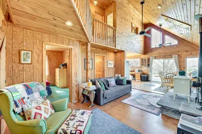 a living room with a couch and a table at 3 Mi to Catskill Trail Stamford Cottage with Views in Stamford