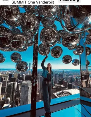 a woman standing on the top of a skyscraper at Apart Studio 12mint From New York City Times Square in West New York
