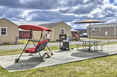 a patio with a table and a chair and an umbrella at 2BR Premium Duplex Close to Ski Slopes in Pleasant Mount