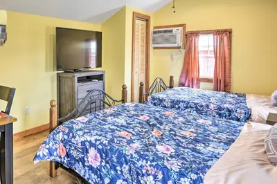 a bedroom with two beds and a tv at Farm Stay Close to Ski Adventures in Pleasant Mount
