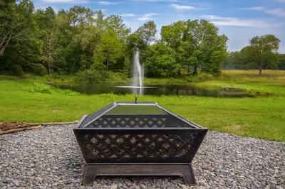 a statue in front of a fountain in a park at Suite to Unwind Close to Ski Slopes in Pleasant Mount