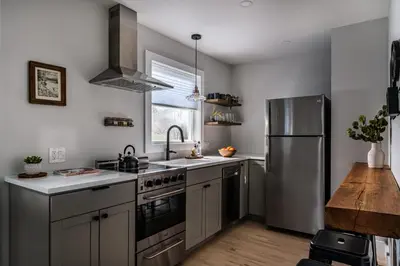 a kitchen with a stainless steel refrigerator and a sink at Perch Cottages #3 - Creek Access, Sauna, Mt views in Boiceville