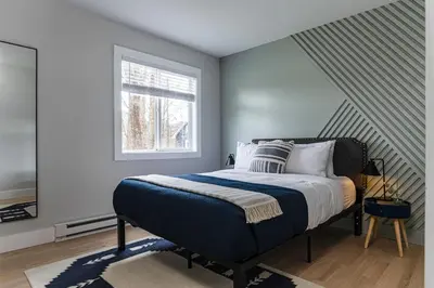 a bedroom with a bed and a window at Perch Cottages #3 - Creek Access, Sauna, Mt views in Boiceville