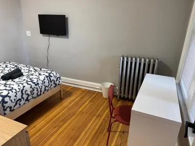 a bedroom with a bed and a desk and a television at Private room in a shared apt Middletown near Wesley uni in Middletown