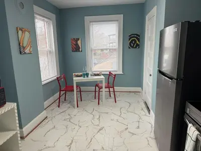 a kitchen with a table and chairs and a refrigerator at Private room in a shared apt Middletown near Wesley uni in Middletown