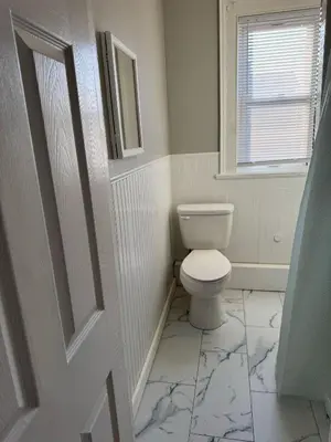 a bathroom with a toilet and a window at Private room in a shared apt Middletown near Wesley uni in Middletown