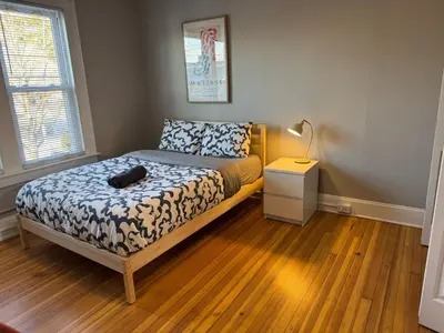 a bedroom with a bed and a lamp on a wooden floor at Private room in a shared apt Middletown near Wesley uni in Middletown