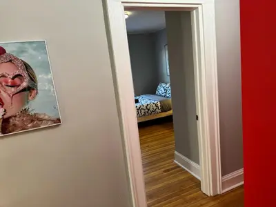 a room with a painting on the wall and a bedroom at Private room in a shared apt Middletown near Wesley uni in Middletown