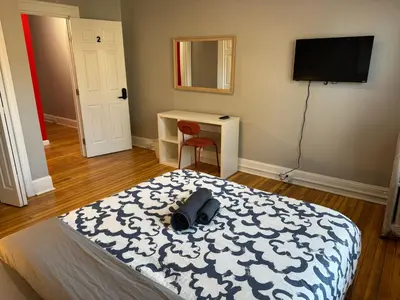 a bedroom with a bed and a desk and a television at Private room in a shared apt Middletown near Wesley uni in Middletown