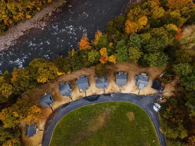 an aerial view of a house with trees and a road at Perch Cottages #9 - Creek Access, Sauna, Mt views in Boiceville