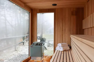 a room with a bench and a large window at Perch Cottages #9 - Creek Access, Sauna, Mt views in Boiceville