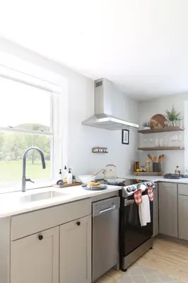a kitchen with white cabinets and a sink and a window at Perch Cottages #11 - Creek Access, Sauna, Mt views in Boiceville