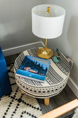 a table with a lamp and a book on it at Perch Cottages #13 - Creek Access, Sauna, Mt views in Boiceville