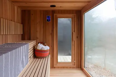 a porch of a sauna with a window and a bucket at Perch Cottages #13 - Creek Access, Sauna, Mt views in Boiceville