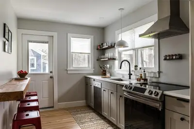 a kitchen with a sink and a stove at Perch Cottages #15 - Creek Access, Sauna, Mt views in Boiceville