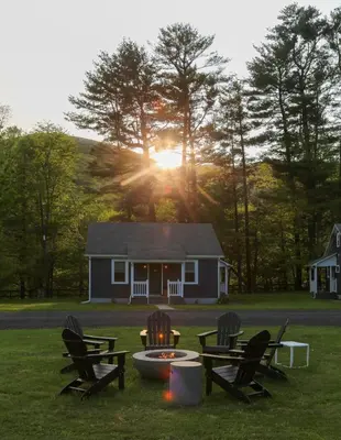 a house with chairs and a fire pit in the grass at Perch Cottages #15 - Creek Access, Sauna, Mt views in Boiceville
