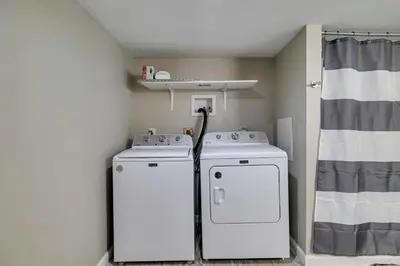 two washing machines in a room with a shower at Pool Access! All-Season Family Home in Poconos in Crescent Lake