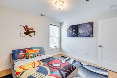 a bedroom with a bed and a window at 10 Mi to Morristown Stylish Home Near Trails! in Denville