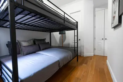a bedroom with a bed with a bunk bed at Prestige NYC Suite in New York