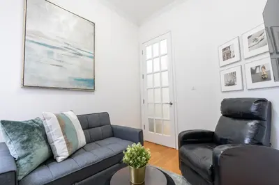 a living room with a couch and a chair at Prestige NYC Suite in New York