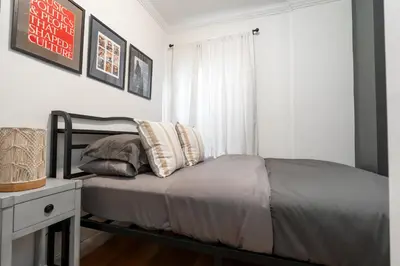 a bed with two pillows on it in a bedroom at Prestige NYC Suite in New York