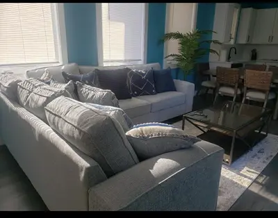 a living room with a couch and a table at Tasteful 3bedroom Vacation home in Newark