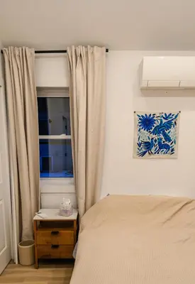 a bedroom with a bed and a window at Peaceful Catskills Creek House in Saugerties