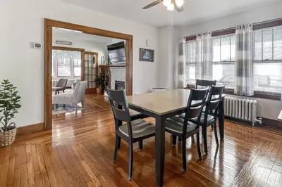 a dining room and living room with a table and chairs at Grove Place Beach West Haven in West Haven