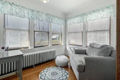 a living room with a couch and some windows at Grove Place Beach West Haven in West Haven