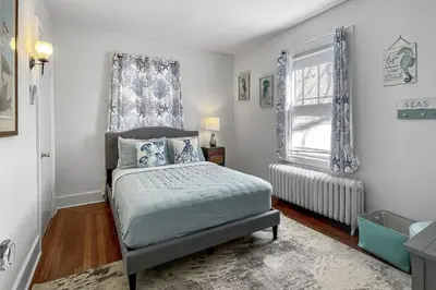a bedroom with a bed and a window at Grove Place Beach West Haven in West Haven