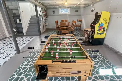 a room with a foosball table and a bowling alley at Grove Place Beach West Haven in West Haven