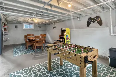 a foosball table in a room with a dining room at Grove Place Beach West Haven in West Haven