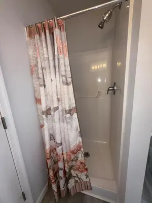 a bathroom with a shower with a shower curtain at Pocono Escape - Modern & Cozy in Pocono Summit