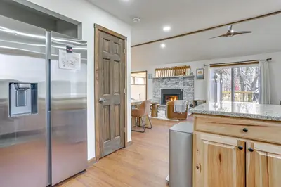 a kitchen with a refrigerator and a living room at Pocono Mountain Family Home with Deck and Grill in Saw Creek
