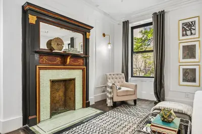 a living room with a fireplace and a chair at The Perfect Apt for Large Groups Sleeps 10 in New York