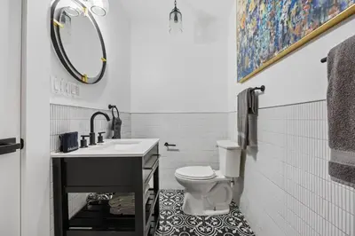 a bathroom with a sink and a toilet and a mirror at The Perfect Apt for Large Groups Sleeps 10 in New York