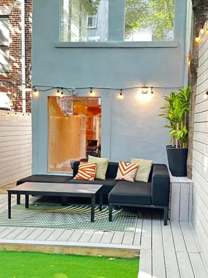 a patio with a couch and a table at The Perfect Apt for Large Groups Sleeps 10 in New York